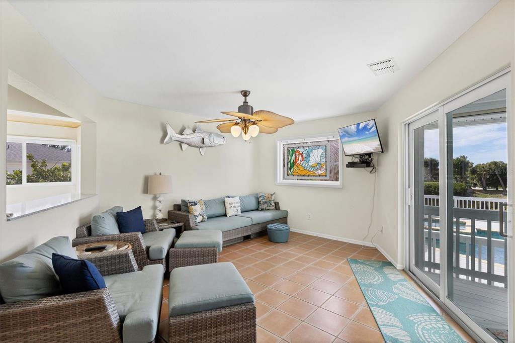 3547 Gasparilla Road Boca Grande, FL 33921 - Photo 12 of 43 a living room with furniture a chandelier and a window