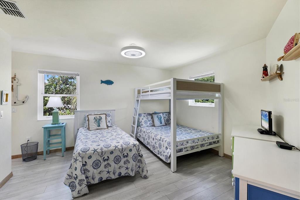 3547 Gasparilla Road Boca Grande, FL 33921 - Photo 16 of 43 a bedroom with two beds and window