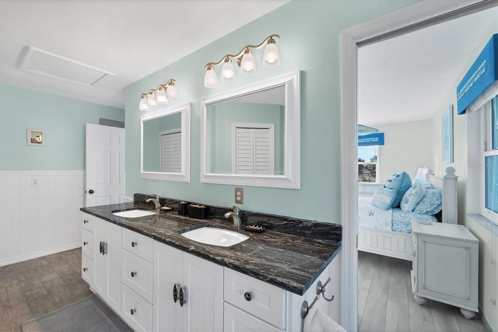 3547 Gasparilla Road Boca Grande, FL 33921 - Photo 18 of 43 a spacious bathroom with a granite countertop sink and a mirror