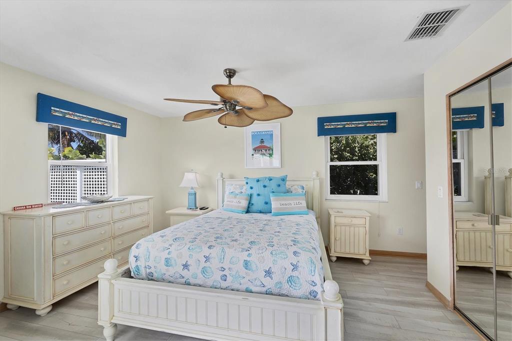 3547 Gasparilla Road Boca Grande, FL 33921 - Photo 21 of 43 a bedroom with a large bed and a window