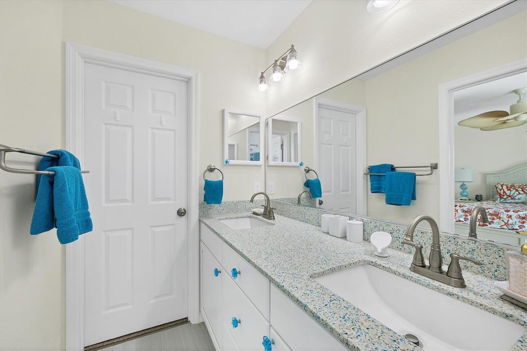 3547 Gasparilla Road Boca Grande, FL 33921 - Photo 28 of 43 a bathroom with a granite countertop sink and a mirror