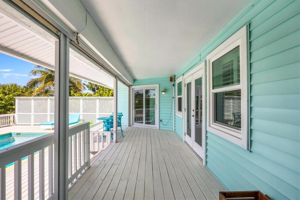 3547 Gasparilla Road Boca Grande, FL 33921 - Photo 31 of 43 a view of a porch with wooden floor and outdoor space