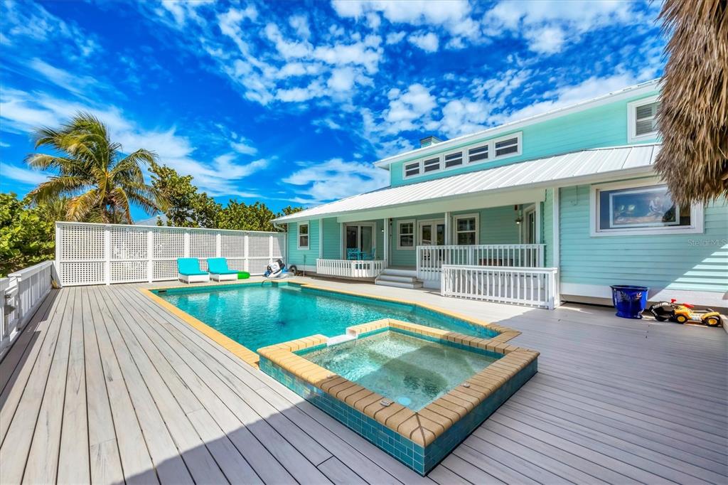 3547 Gasparilla Road Boca Grande, FL 33921 - Photo 35 of 43 a view of a house with pool fire pit and wooden floor