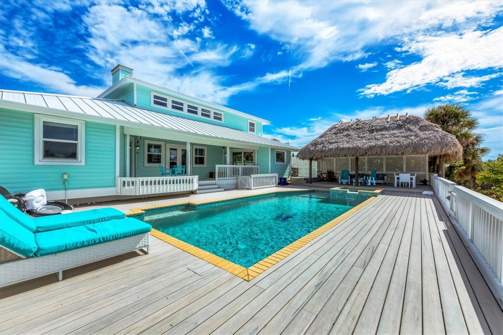 3547 Gasparilla Road Boca Grande, FL 33921 - Photo 36 of 43 a view of a house with swimming pool and sitting area