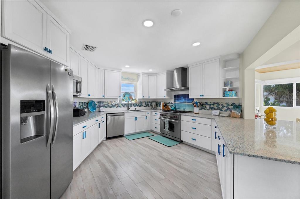 3547 Gasparilla Road Boca Grande, FL 33921 - Photo 6 of 43 a kitchen with granite countertop stainless steel appliances and white cabinets