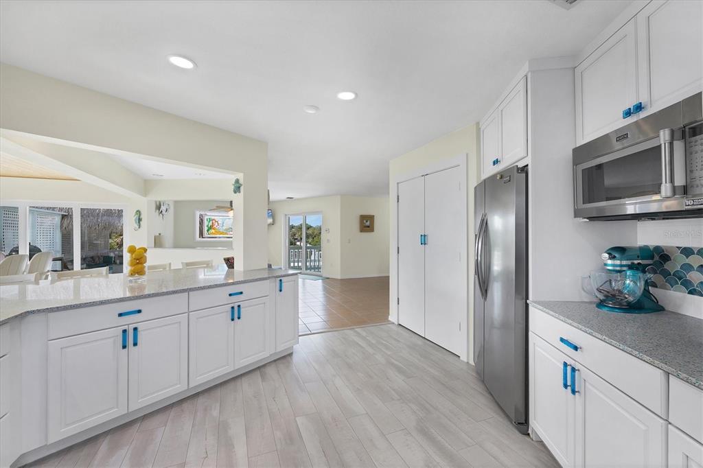 3547 Gasparilla Road Boca Grande, FL 33921 - Photo 7 of 43 a kitchen with granite countertop cabinets stainless steel appliances and a counter space