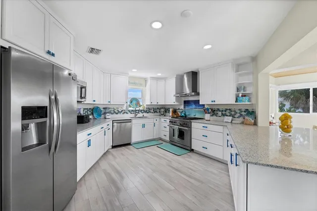 a living room with furniture a chandelier and a window