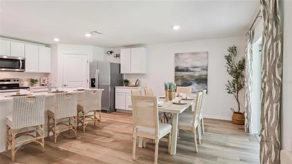 a kitchen with a table and chairs in it