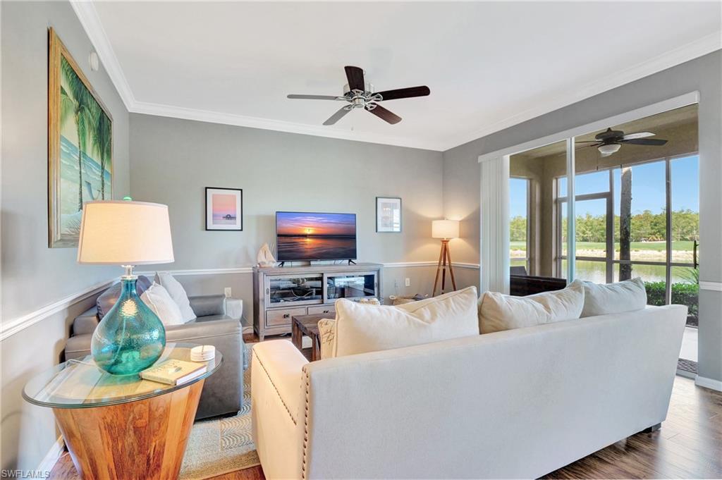 8600 Cedar Hammock Circle, Unit 1313 Naples, FL 34112 - Photo 11 of 41 a living room with furniture and a flat screen tv