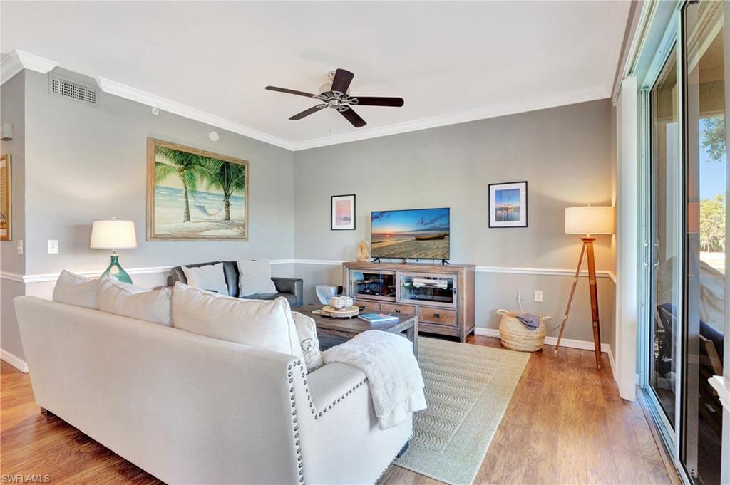 8600 Cedar Hammock Circle, Unit 1313 Naples, FL 34112 - Photo 12 of 41 a living room with furniture and a wooden floor