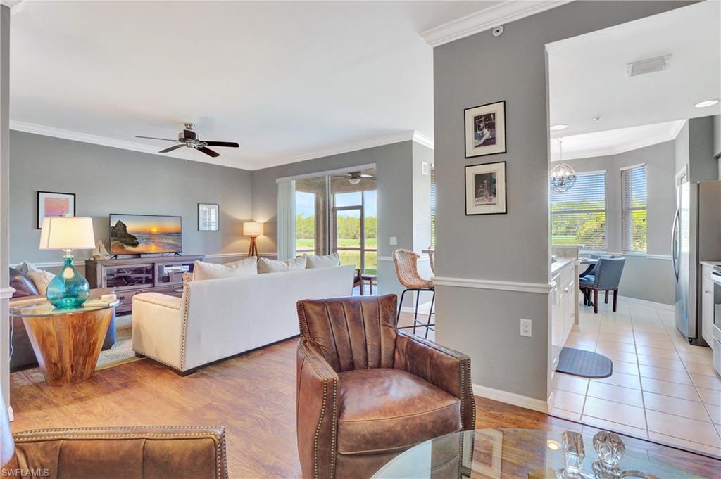 8600 Cedar Hammock Circle, Unit 1313 Naples, FL 34112 - Photo 13 of 41 a living room with furniture and a wooden floor