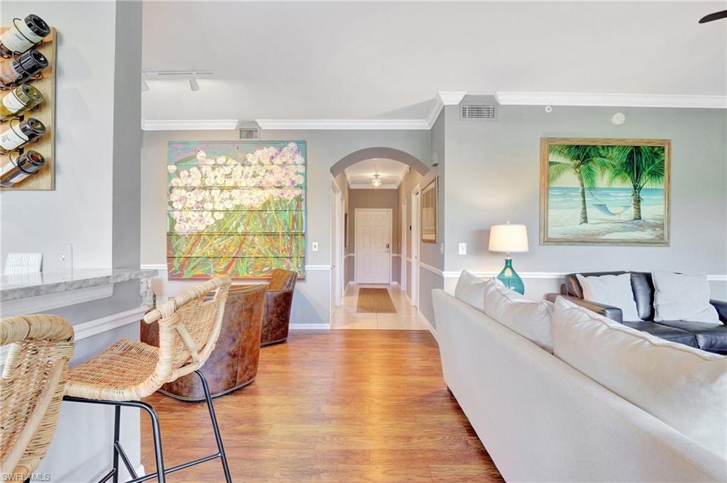 8600 Cedar Hammock Circle, Unit 1313 Naples, FL 34112 - Photo 15 of 41 a living room with furniture and a large window