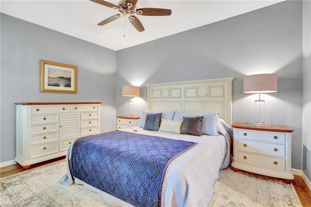 8600 Cedar Hammock Circle, Unit 1313 Naples, FL 34112 - Photo 16 of 41 a bedroom with a bed and a lamp on the dresser