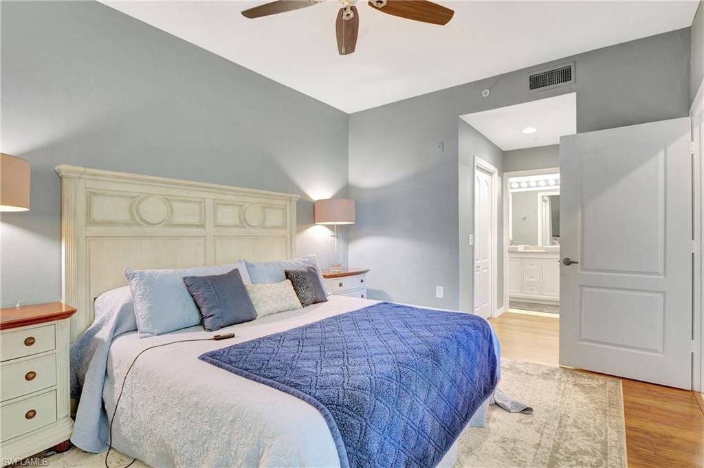 8600 Cedar Hammock Circle, Unit 1313 Naples, FL 34112 - Photo 18 of 41 a bedroom with a bed and a walk in closet