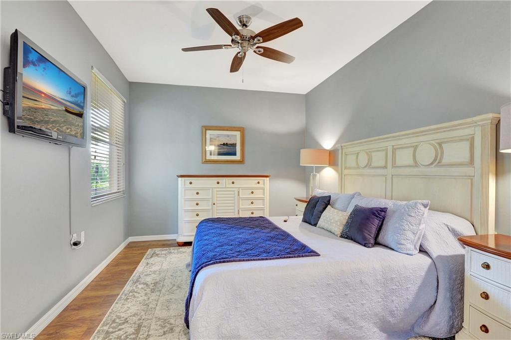 8600 Cedar Hammock Circle, Unit 1313 Naples, FL 34112 - Photo 19 of 41 a bedroom with a large bed and a tv