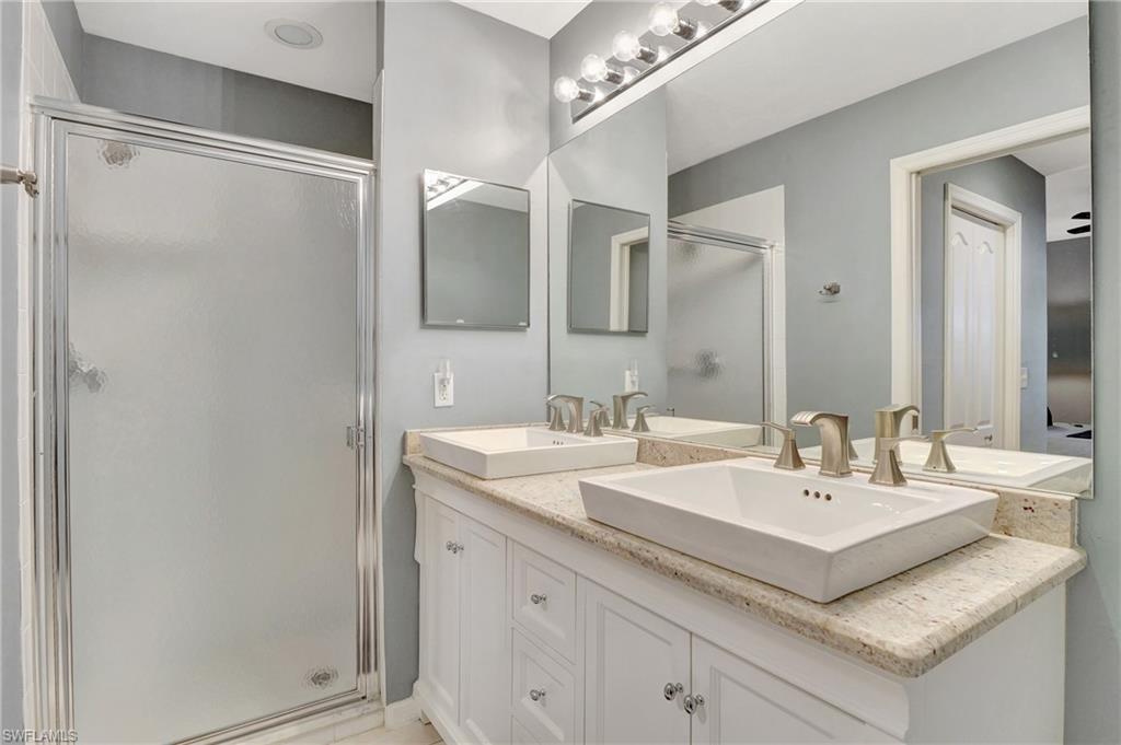 8600 Cedar Hammock Circle, Unit 1313 Naples, FL 34112 - Photo 20 of 41 a bathroom with a sink and a mirror