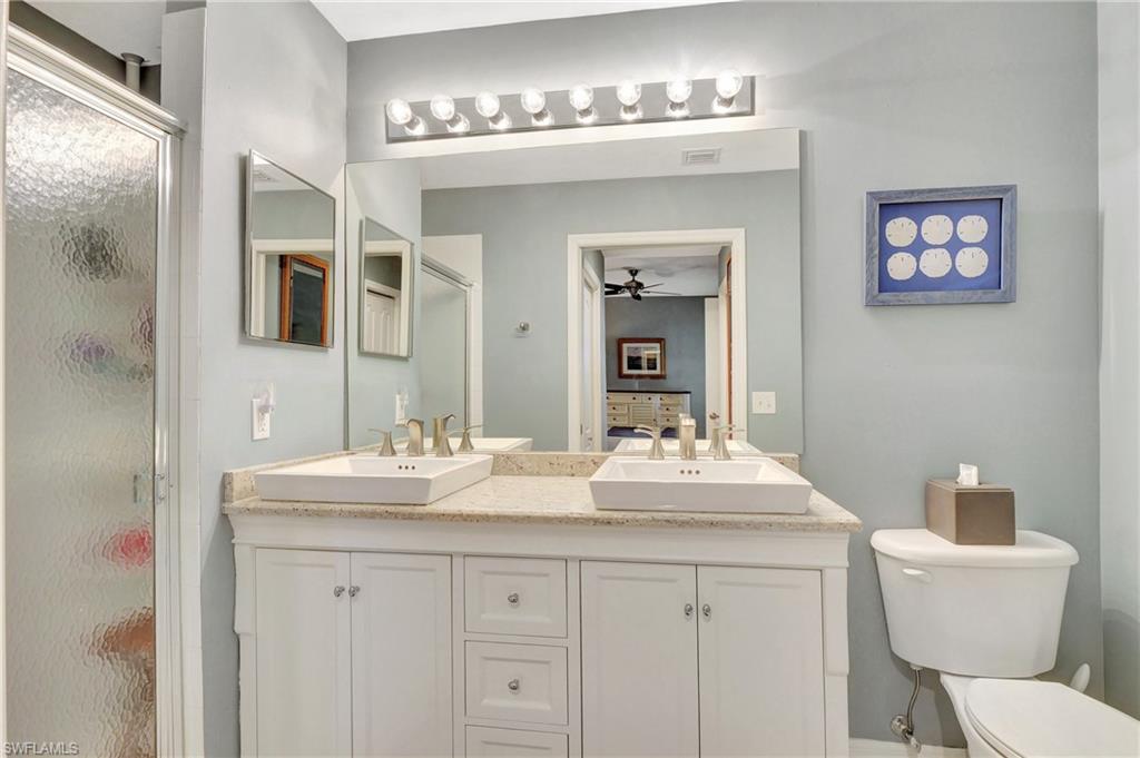 8600 Cedar Hammock Circle, Unit 1313 Naples, FL 34112 - Photo 21 of 41 a bathroom with a sink and a mirror