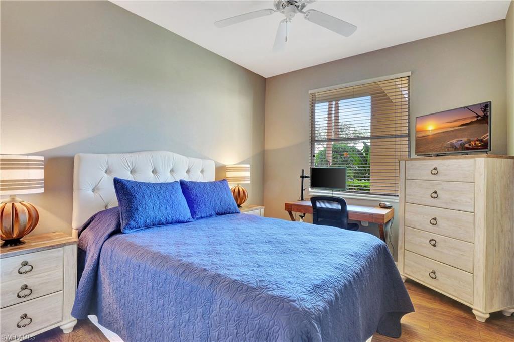 8600 Cedar Hammock Circle, Unit 1313 Naples, FL 34112 - Photo 22 of 41 a bedroom with a bed and a flat screen tv