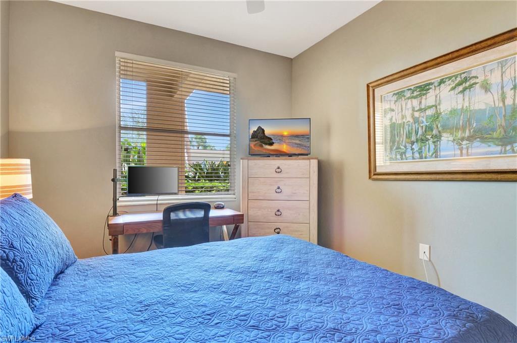 8600 Cedar Hammock Circle, Unit 1313 Naples, FL 34112 - Photo 24 of 41 a bedroom with a bed and a window