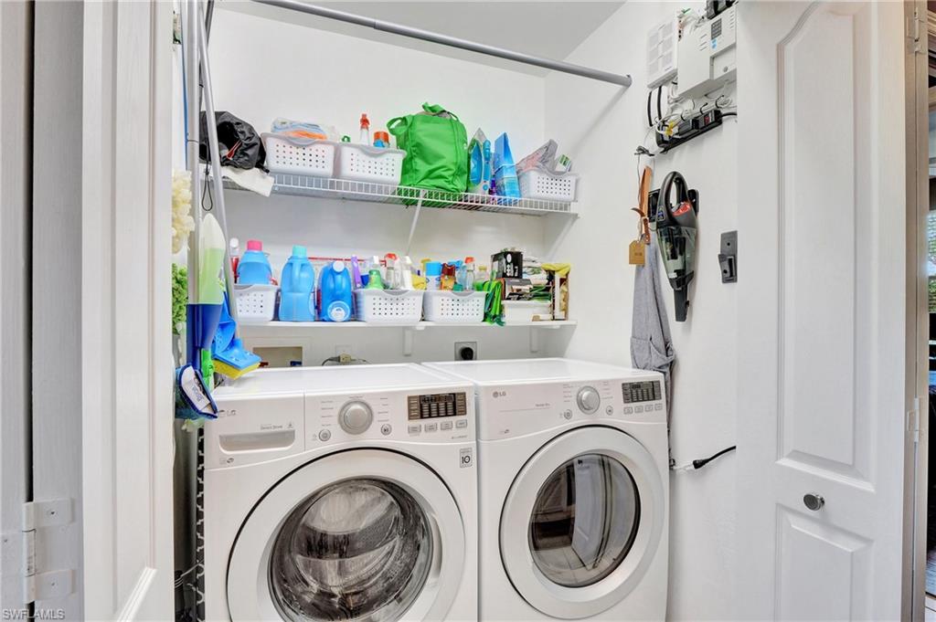 8600 Cedar Hammock Circle, Unit 1313 Naples, FL 34112 - Photo 26 of 41 a view of washer and dryer in a utility room