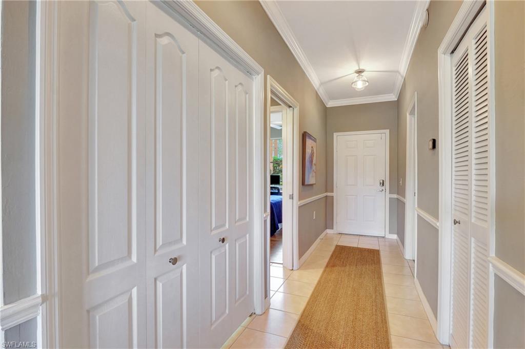 8600 Cedar Hammock Circle, Unit 1313 Naples, FL 34112 - Photo 3 of 41 a view of a hallway with a wooden door