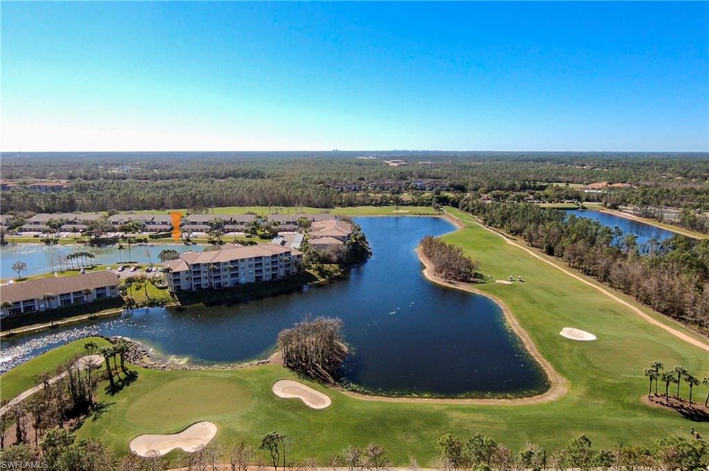 8600 Cedar Hammock Circle, Unit 1313 Naples, FL 34112 - Photo 35 of 41 a view of a lake with a yard