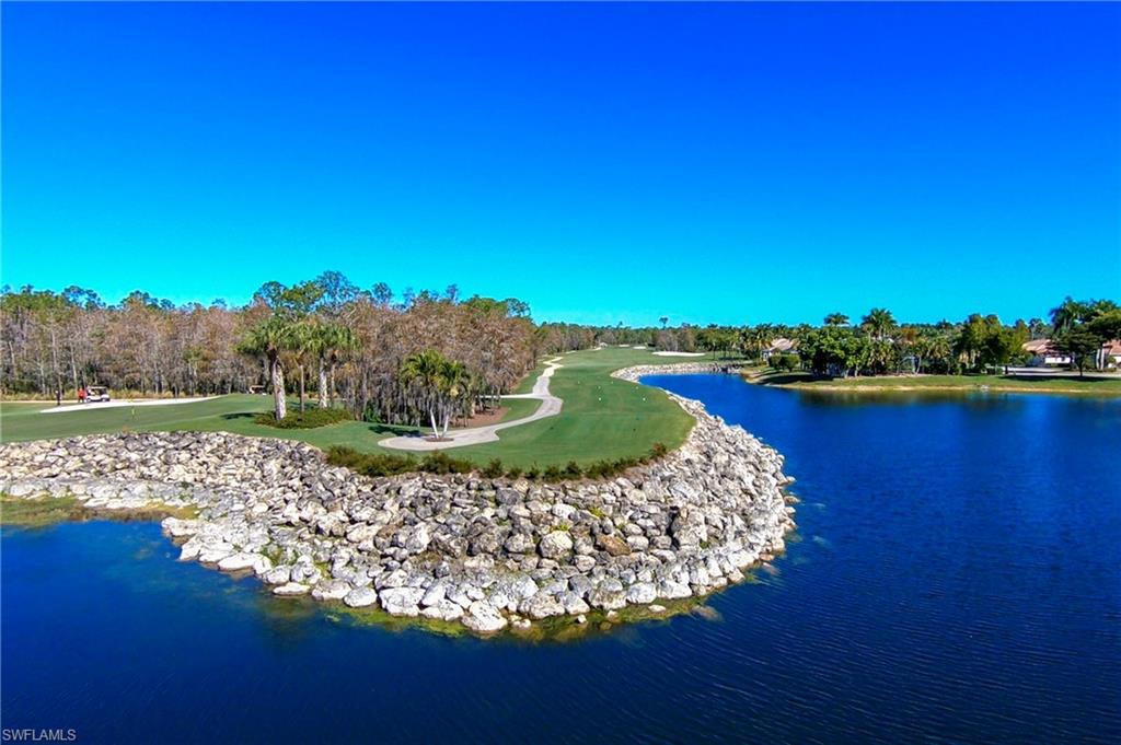 8600 Cedar Hammock Circle, Unit 1313 Naples, FL 34112 - Photo 37 of 41 a view of a lake with a house in the background