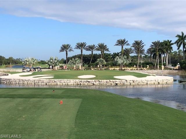 8600 Cedar Hammock Circle, Unit 1313 Naples, FL 34112 - Photo 38 of 41 a view of a golf course with a lake