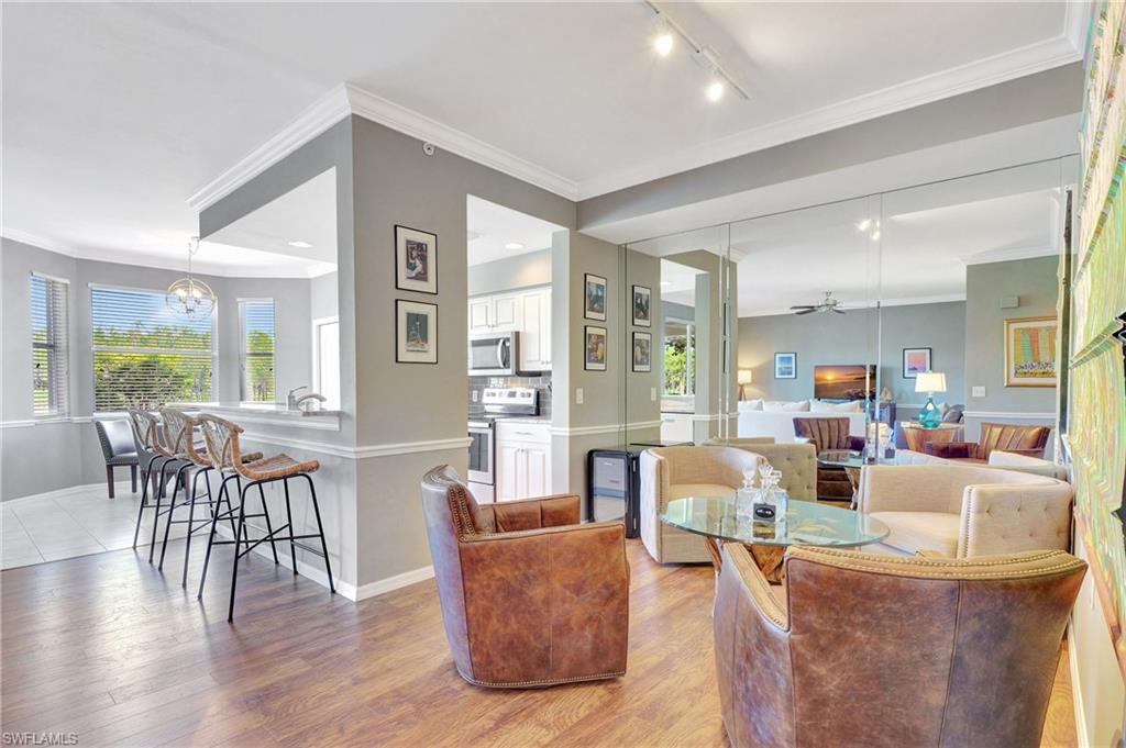 8600 Cedar Hammock Circle, Unit 1313 Naples, FL 34112 - Photo 4 of 41 a living room with furniture and wooden floor