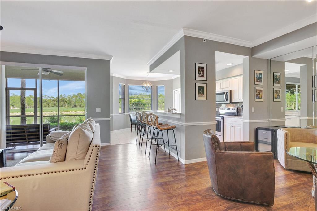 8600 Cedar Hammock Circle, Unit 1313 Naples, FL 34112 - Photo 5 of 41 a living room with furniture and a large window