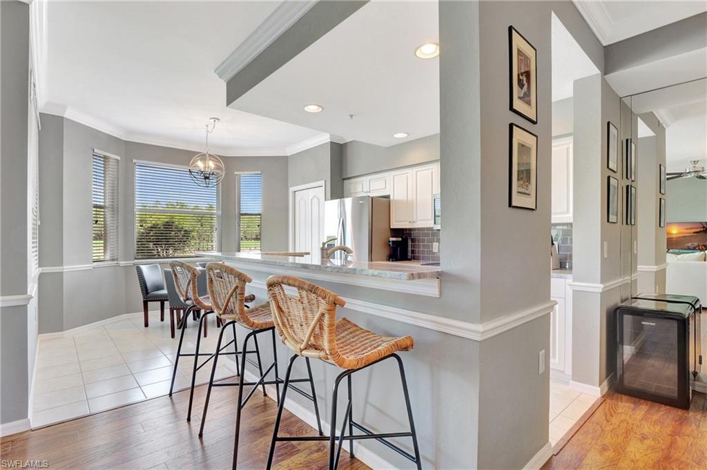 8600 Cedar Hammock Circle, Unit 1313 Naples, FL 34112 - Photo 6 of 41 a view of a dining room with furniture window and wooden floor