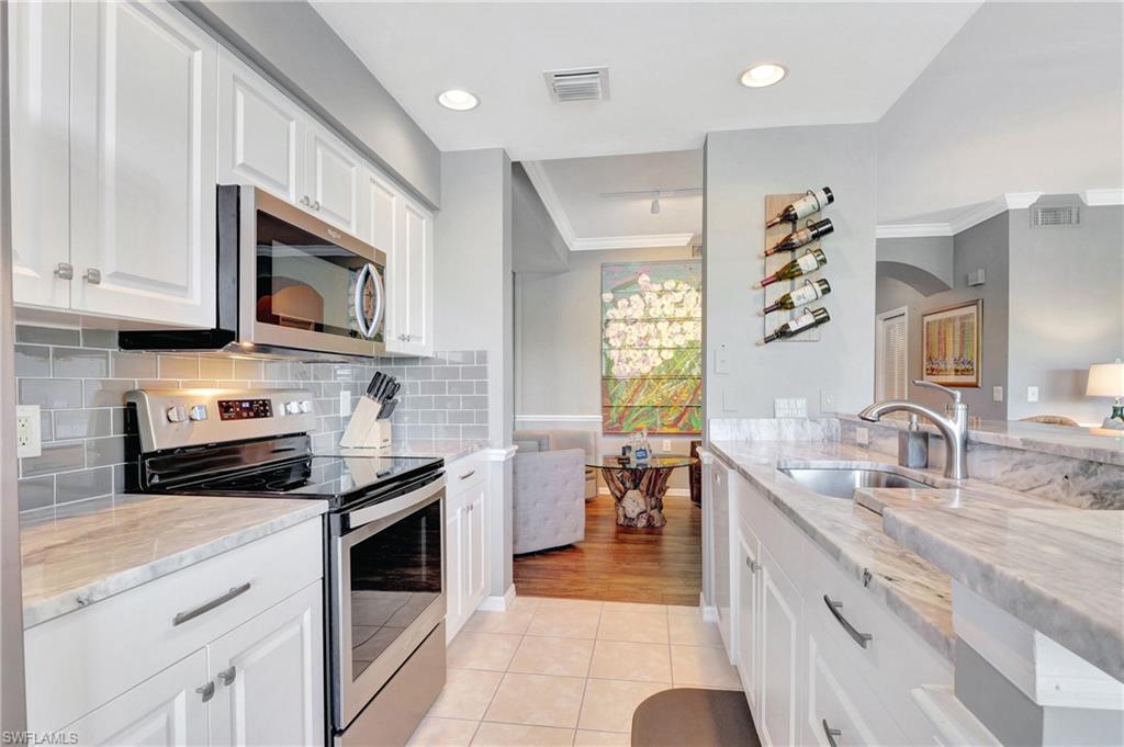 8600 Cedar Hammock Circle, Unit 1313 Naples, FL 34112 - Photo 8 of 41 a kitchen with a sink stove and microwave