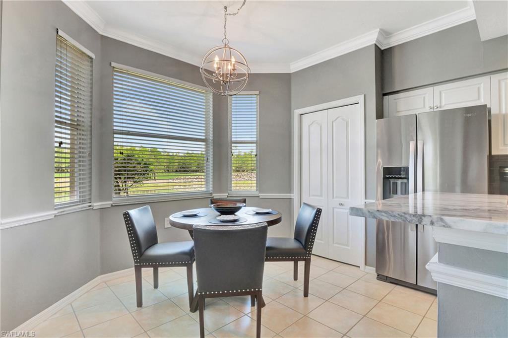 8600 Cedar Hammock Circle, Unit 1313 Naples, FL 34112 - Photo 10 of 41 a view of a dining room with furniture window and outside view