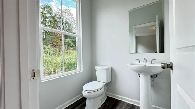 a bathroom with a sink toilet and a mirror