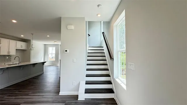 a view of entryway and hall with wooden floor