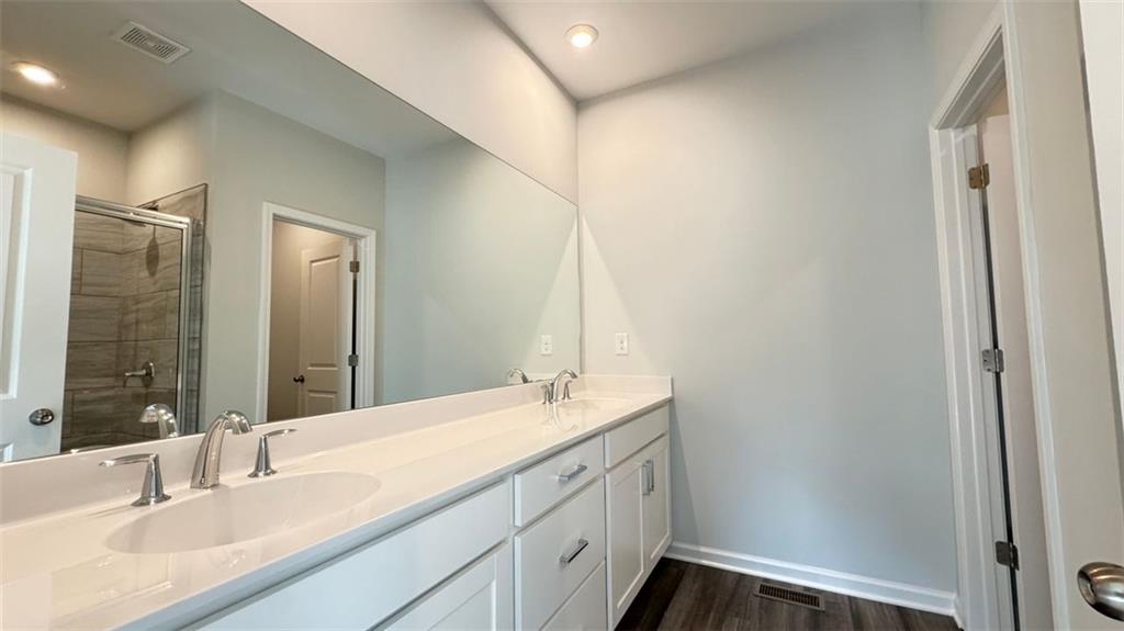 1479 Creekside Circle Northwest Atlanta, GA 30318 - Photo 25 of 42 a bathroom with a double vanity sink and a mirror