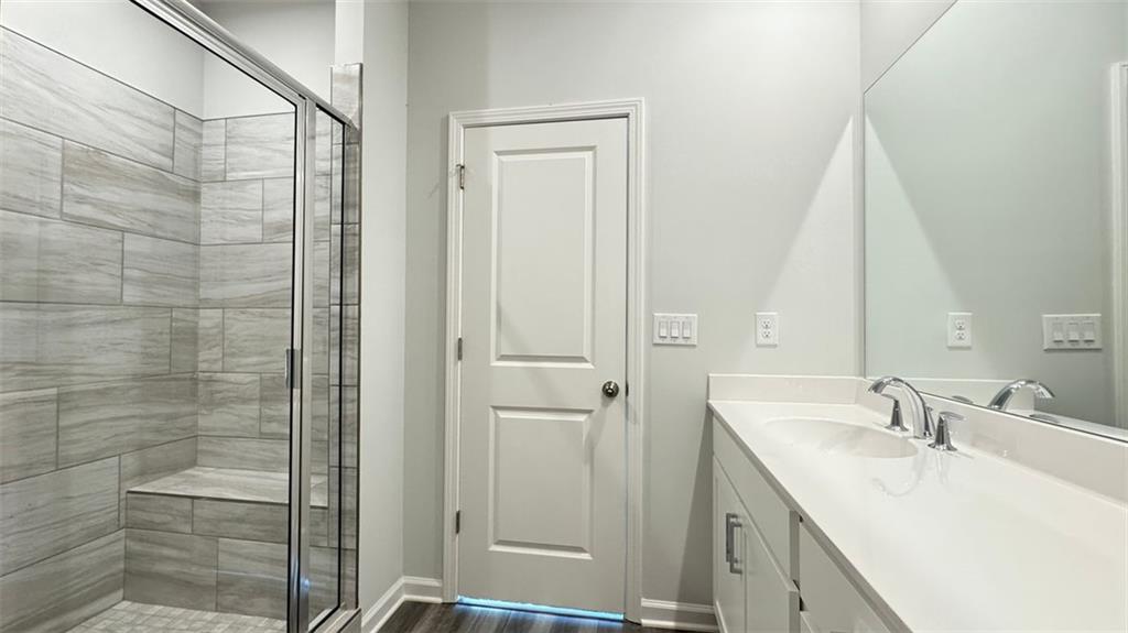 1479 Creekside Circle Northwest Atlanta, GA 30318 - Photo 26 of 42 a bathroom with a sink and mirror