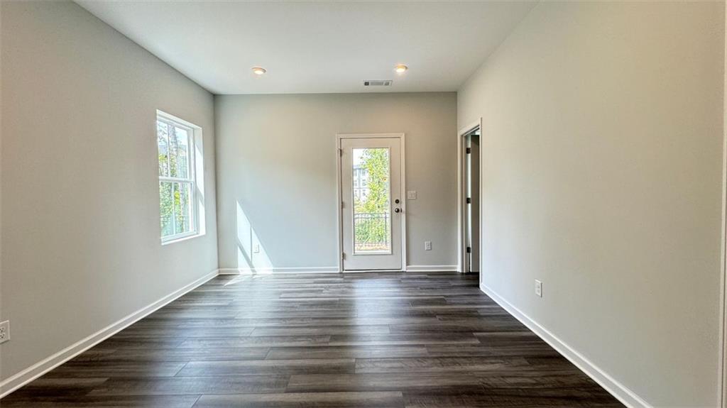1479 Creekside Circle Northwest Atlanta, GA 30318 - Photo 28 of 42 a view of an empty room with wooden floor and a window