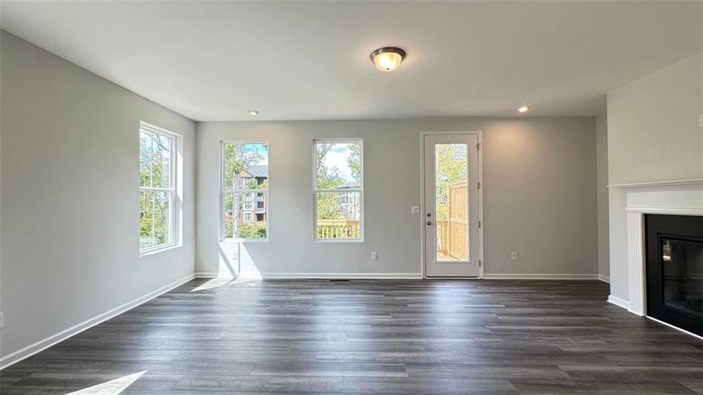 1479 Creekside Circle Northwest Atlanta, GA 30318 - Photo 9 of 42 an empty room with wooden floor and windows