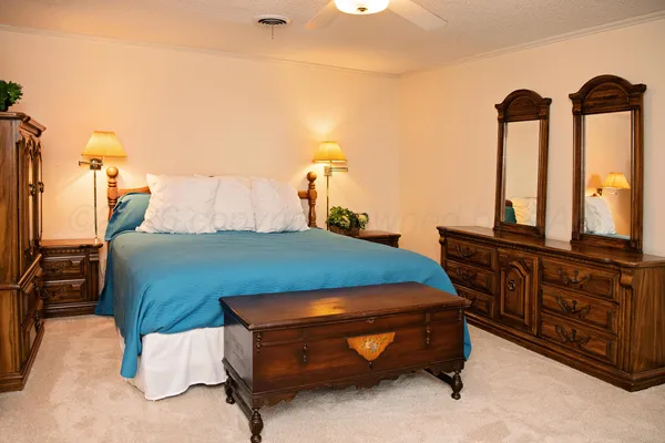 a bedroom with a bed and two night stand