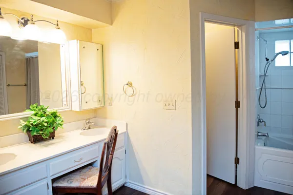 a bathroom with a sink a mirror and a shower