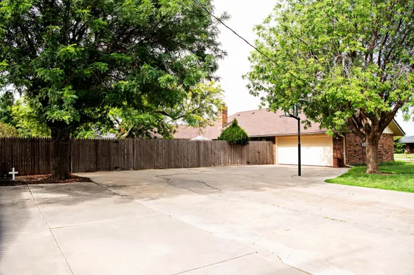 a wooden fence under a large tree