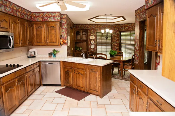 a kitchen with stainless steel appliances granite countertop a sink and cabinets