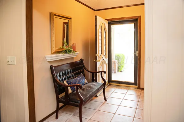 a view of a hallway with an outdoor dining space and a mirror