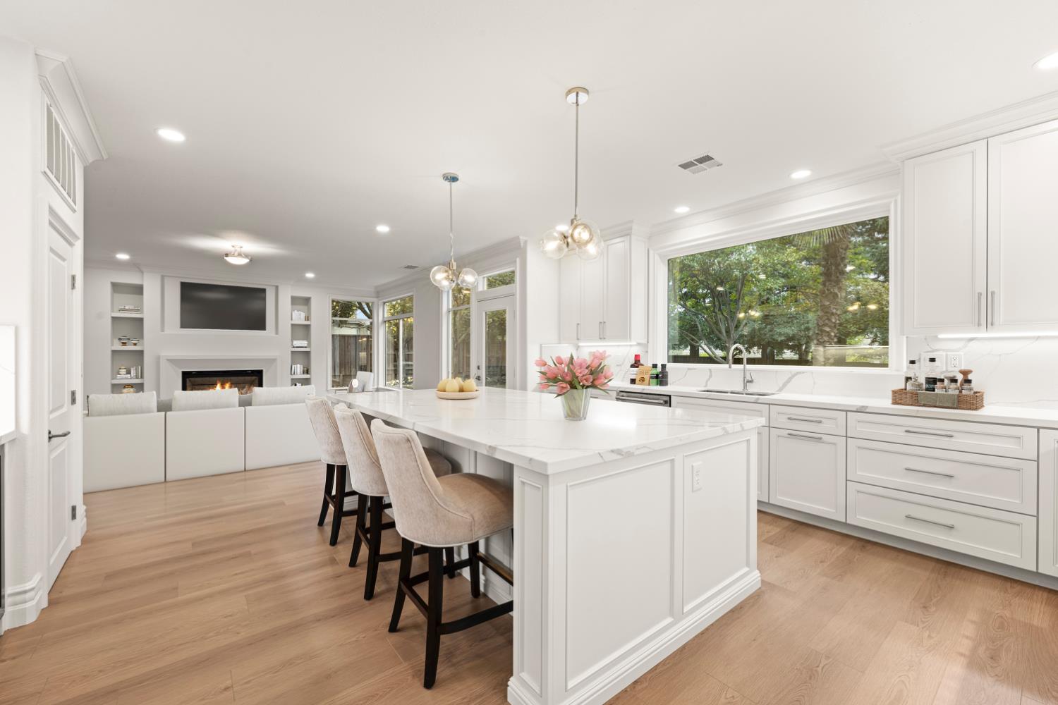 9337 Crocker Road Granite Bay, CA 95746 - Photo 21 of 56 a kitchen with stainless steel appliances kitchen island granite countertop a table chairs sink and cabinets