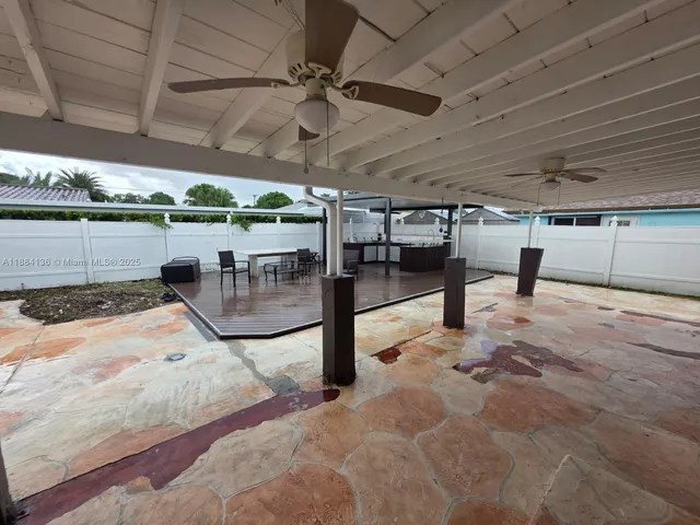 a view of a swimming pool with a table and chairs