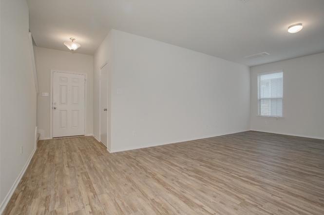 148 Spotted Rail Ridge Leander, TX 78641 - Photo 6 of 31 A welcoming entry foyer transitions seamlessly to a spacious living area with resilient wood flooring.