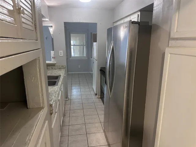 a view of a hallway with wooden floor and a fireplace