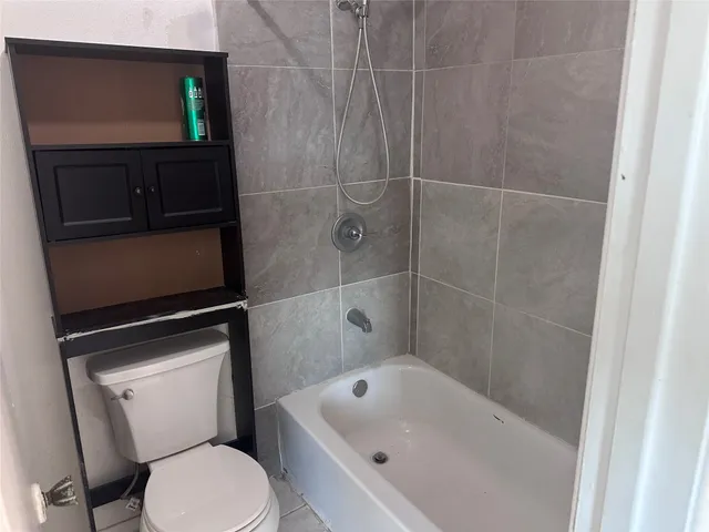 a bathroom with a toilet a sink and bathtub