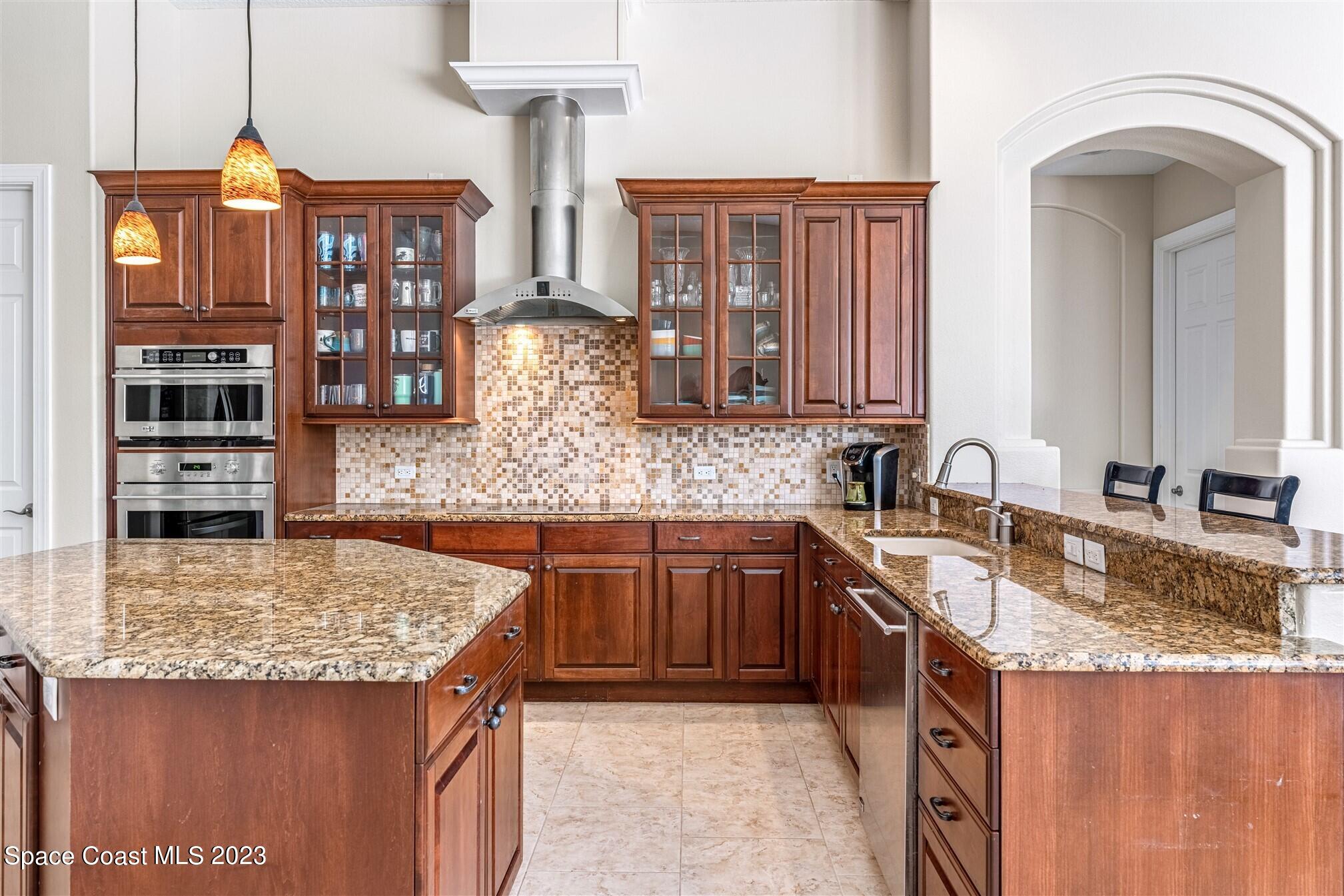 3550 Thurloe Drive Rockledge, FL 32955 - Photo 13 of 44 a kitchen with stainless steel appliances granite countertop a sink stove and cabinets